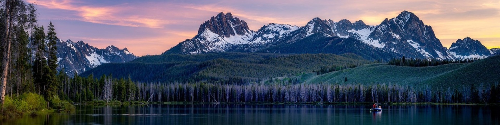 Idaho Mountain lake, snowcapped mountains with raft